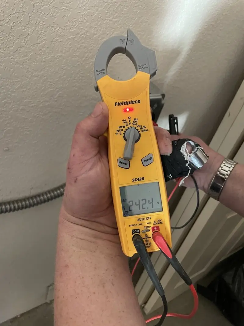 Voltage testing with clamp meter during Electrical Installation Services in Ridgway